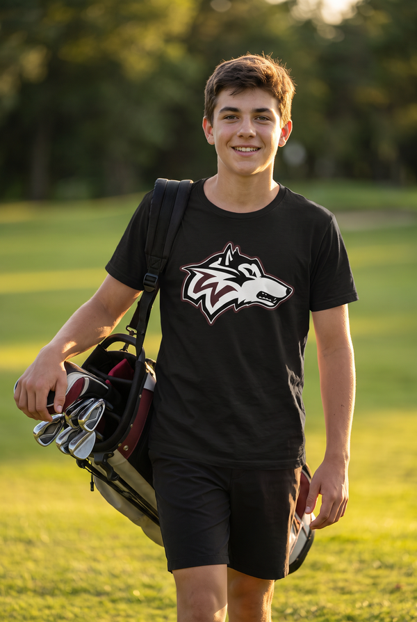 Woodcreek Boys Golf Value Tee in Black with the Woodcreek wolf head across the chest, worn walking the fairway