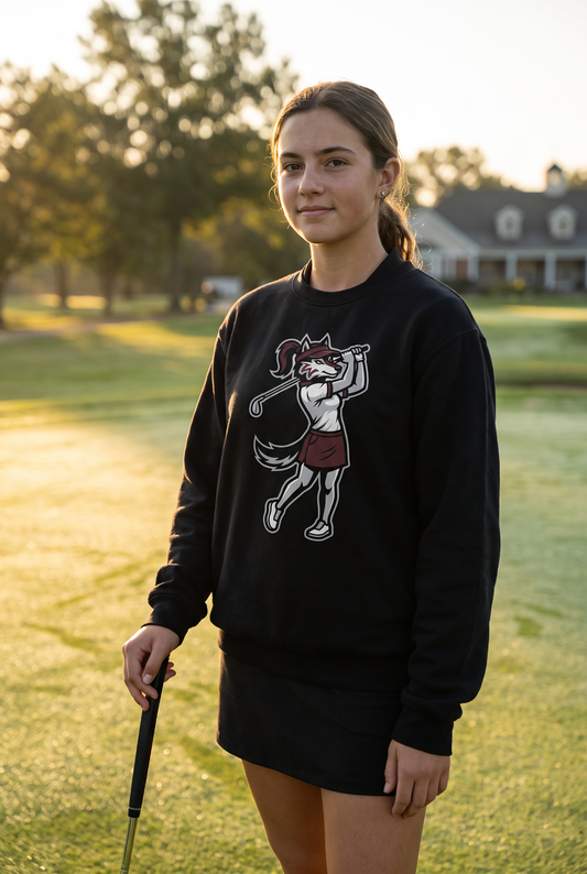 Woodcreek Girls Golf Swing Wolf Fleece Crewneck in Black with the girls Swing Wolf mascot across the chest, worn on the practice green