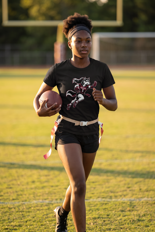 Woodcreek Girls Flag Football Stiff Arm Value Tee in Black, worn jogging onto the field